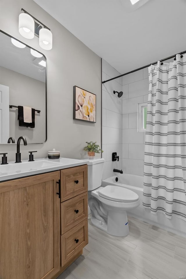 full bathroom featuring shower / bath combo with shower curtain, toilet, and vanity