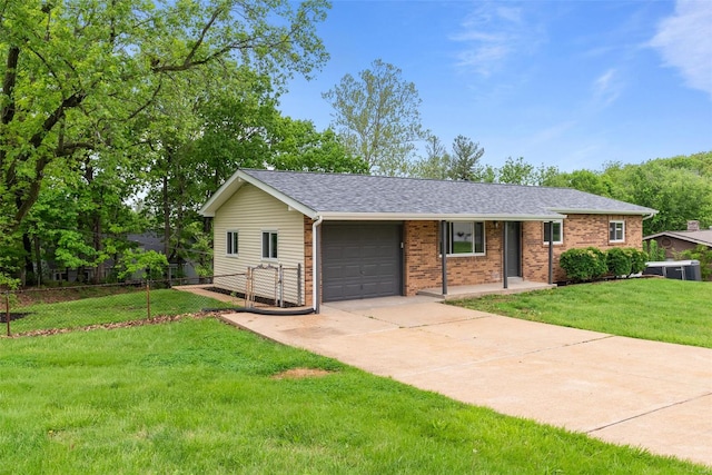 single story home featuring fence, an attached garage, a front lawn, brick siding, and driveway