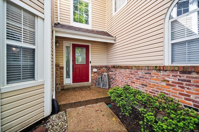 entrance to property with brick siding