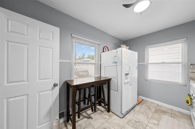 laundry area featuring baseboards and ceiling fan