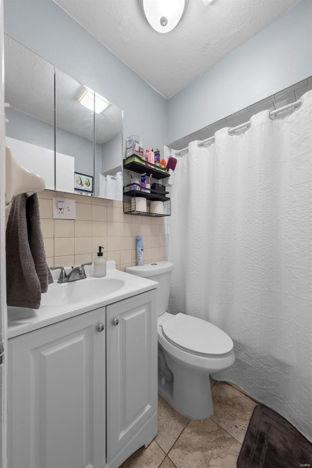 full bath featuring vanity, a textured ceiling, toilet, and tasteful backsplash