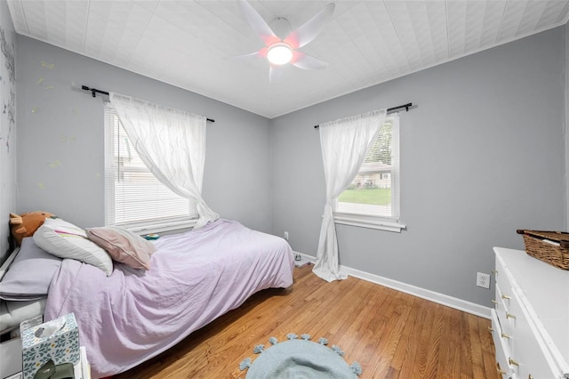bedroom with baseboards, a ceiling fan, and light wood finished floors