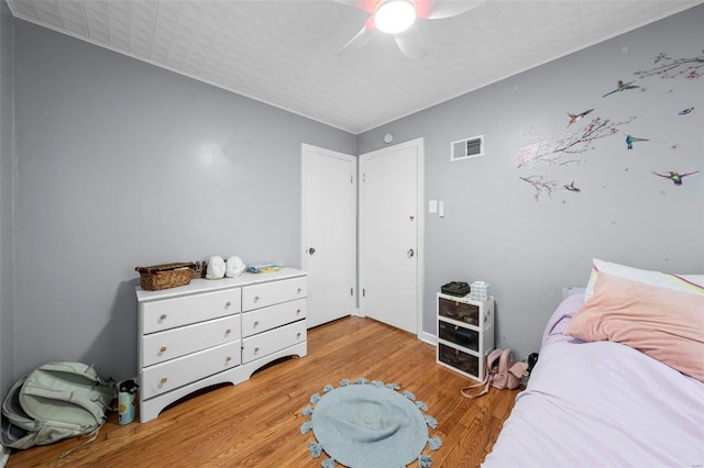 bedroom with visible vents, ceiling fan, and light wood-type flooring