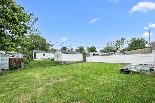 view of yard with an outdoor fire pit and fence
