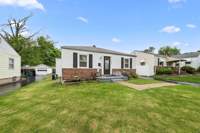 bungalow with an outbuilding, cooling unit, a front yard, and brick siding