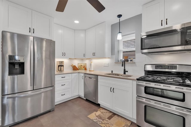 kitchen with a ceiling fan, a sink, light countertops, white cabinets, and stainless steel appliances