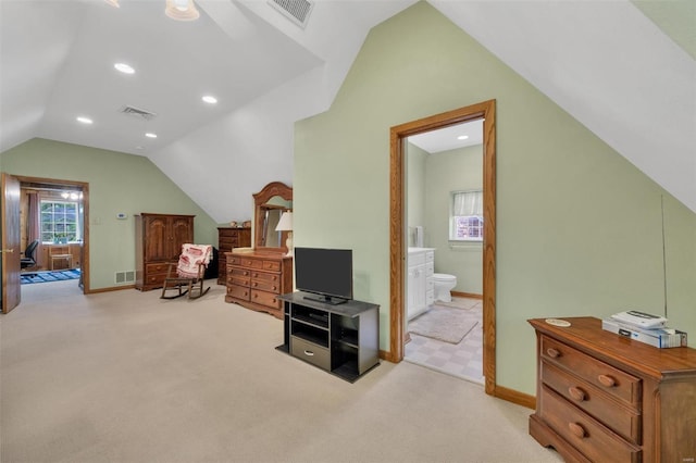 bedroom with visible vents, light carpet, and lofted ceiling