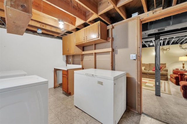 finished basement featuring separate washer and dryer and refrigerator