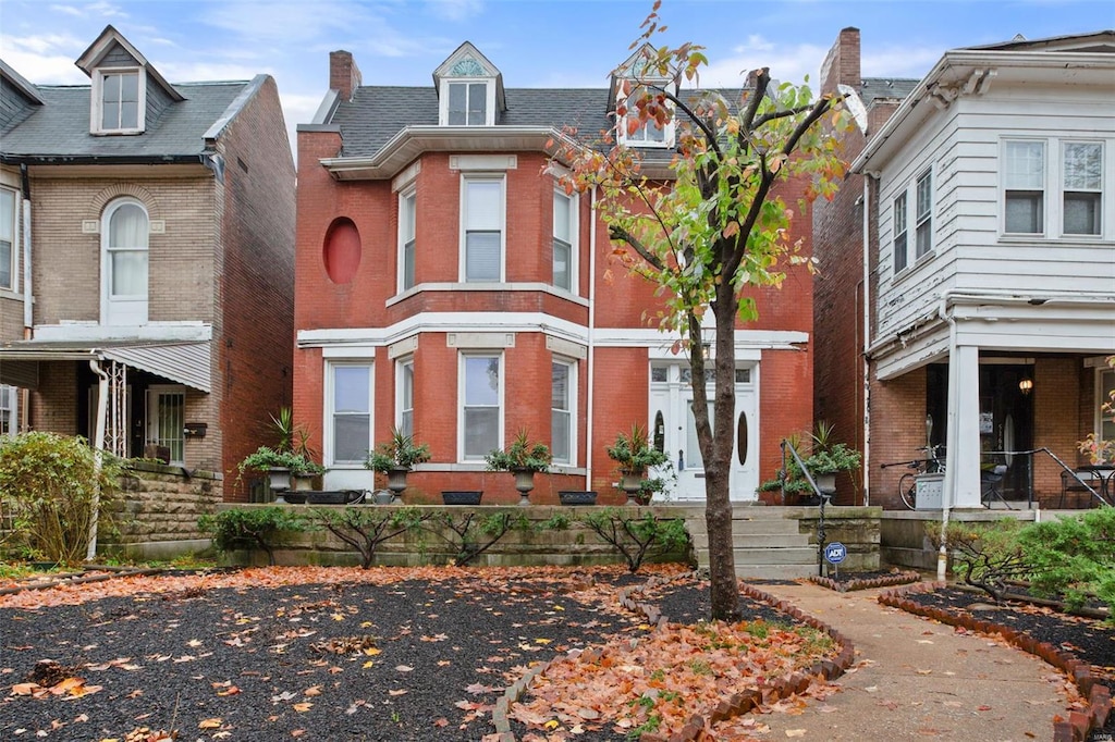 townhome / multi-family property featuring brick siding