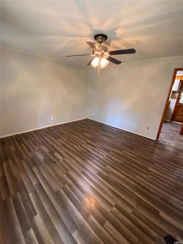empty room with a ceiling fan and dark wood-style floors