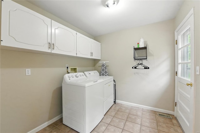 washroom with cabinet space, washer and clothes dryer, baseboards, and light tile patterned flooring