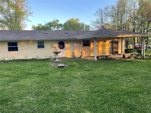 back of property featuring a yard