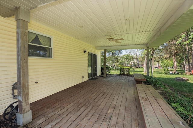 deck featuring a yard and ceiling fan