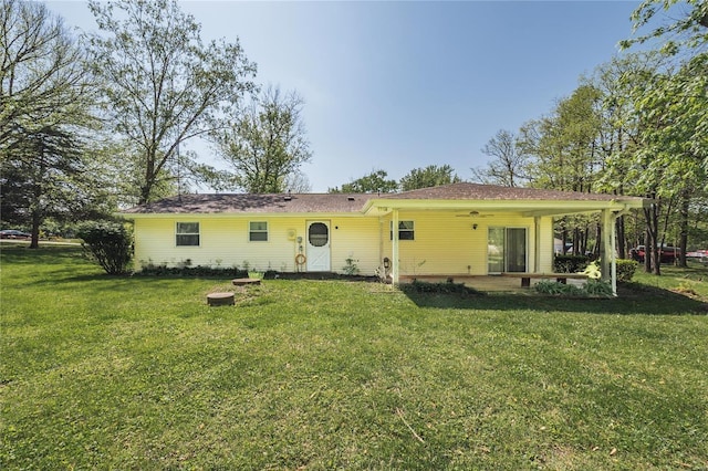 rear view of property with a patio and a yard