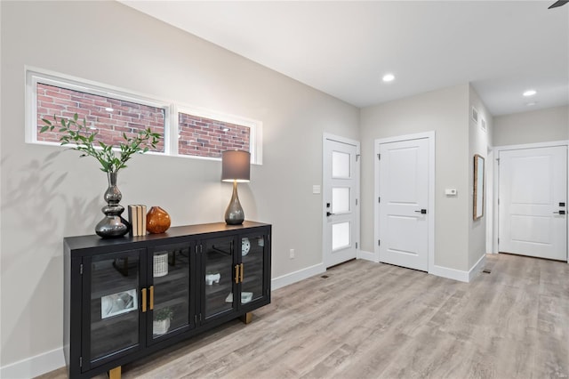 entrance foyer featuring light wood-style floors, recessed lighting, and baseboards