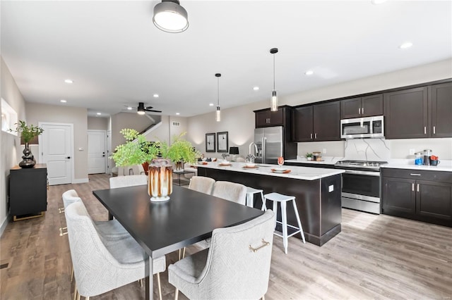 dining space with recessed lighting, ceiling fan, and light wood finished floors