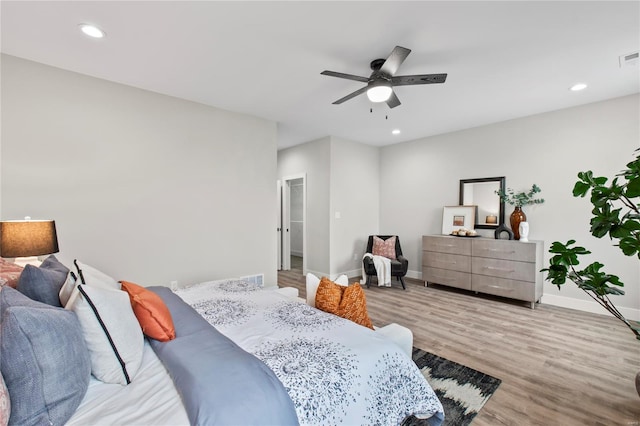 bedroom featuring recessed lighting, ceiling fan, light wood finished floors, baseboards, and visible vents