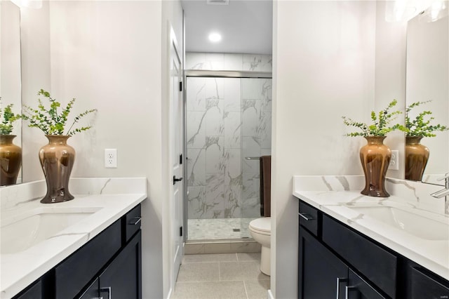 full bath with a sink, two vanities, and a marble finish shower