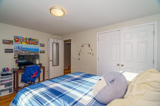 bedroom featuring a closet and wood finished floors