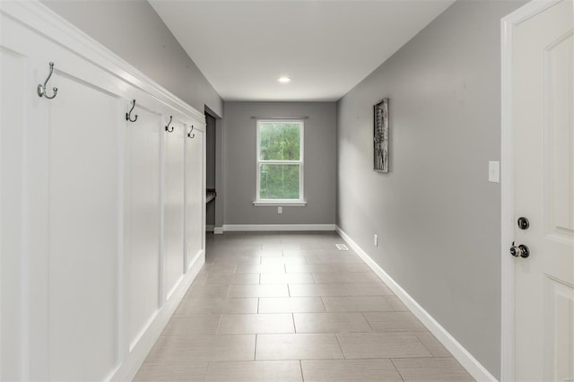 mudroom with recessed lighting, baseboards, and light tile patterned flooring