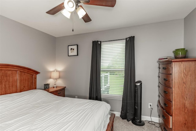 bedroom with baseboards, ceiling fan, and light colored carpet