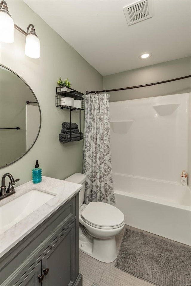 bathroom featuring shower / bath combination with curtain, visible vents, tile patterned floors, vanity, and toilet
