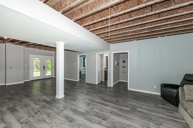 below grade area with baseboards, french doors, and dark wood-type flooring
