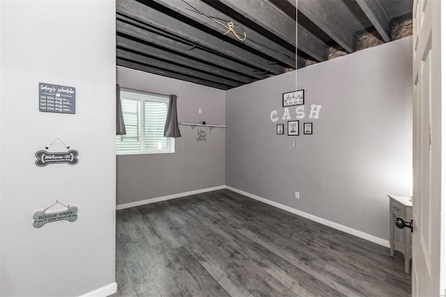 below grade area with baseboards and wood finished floors