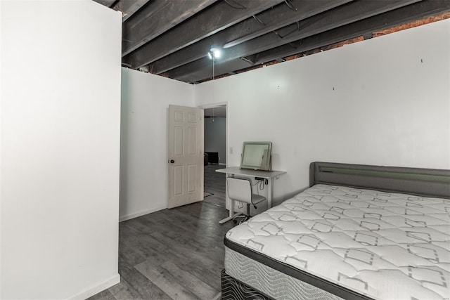 bedroom with baseboards and wood finished floors