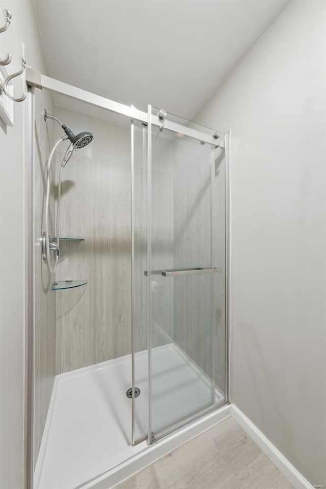 bathroom featuring baseboards and a stall shower