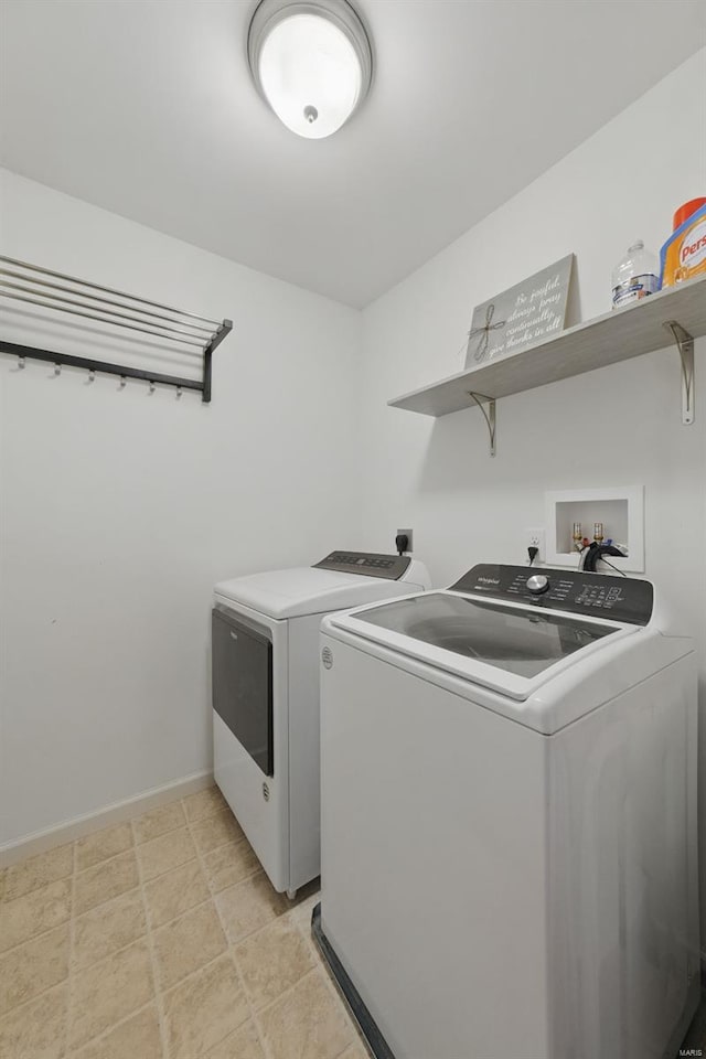 washroom with separate washer and dryer, baseboards, and laundry area