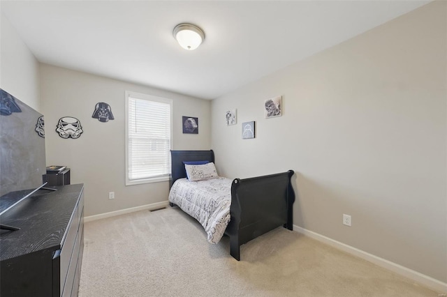 bedroom with baseboards, visible vents, and light colored carpet