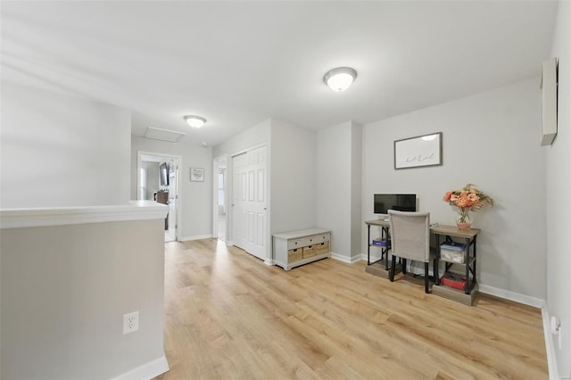 office with light wood-type flooring, attic access, and baseboards