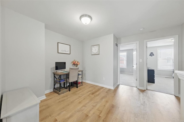 office area with baseboards and wood finished floors