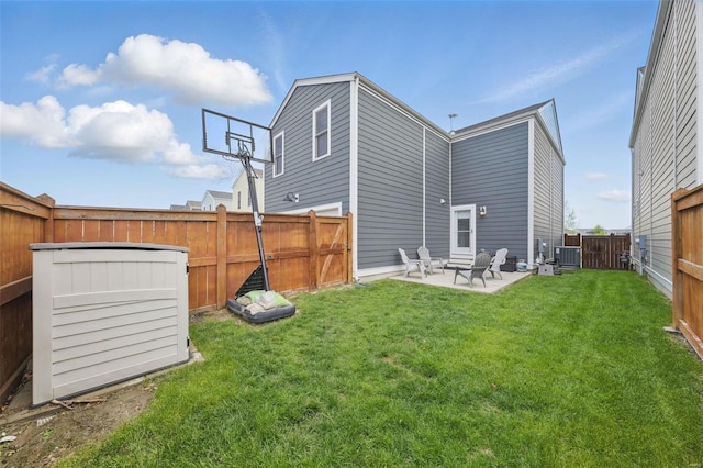 back of house featuring a lawn, central AC unit, a fenced backyard, and a patio
