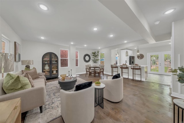 living room featuring recessed lighting, wood finished floors, a wealth of natural light, and french doors
