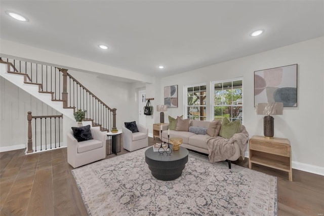 living area featuring baseboards, stairway, wood finished floors, and recessed lighting