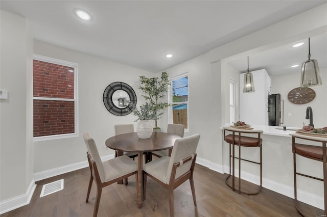 dining area with recessed lighting, visible vents, baseboards, and dark wood finished floors