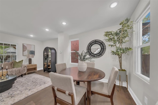 dining room with recessed lighting, wood finished floors, and baseboards