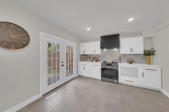 kitchen with visible vents, light countertops, gas stove, wall chimney exhaust hood, and french doors