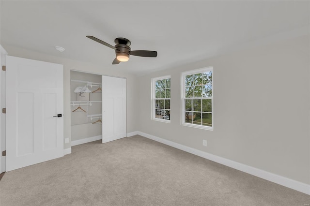 unfurnished bedroom featuring baseboards, a ceiling fan, a closet, and carpet flooring