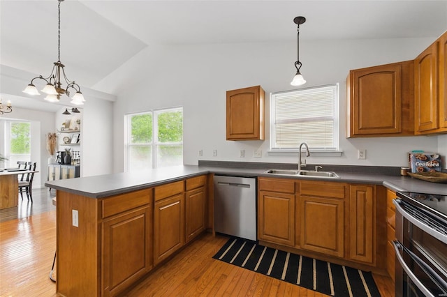kitchen with a sink, appliances with stainless steel finishes, plenty of natural light, and vaulted ceiling