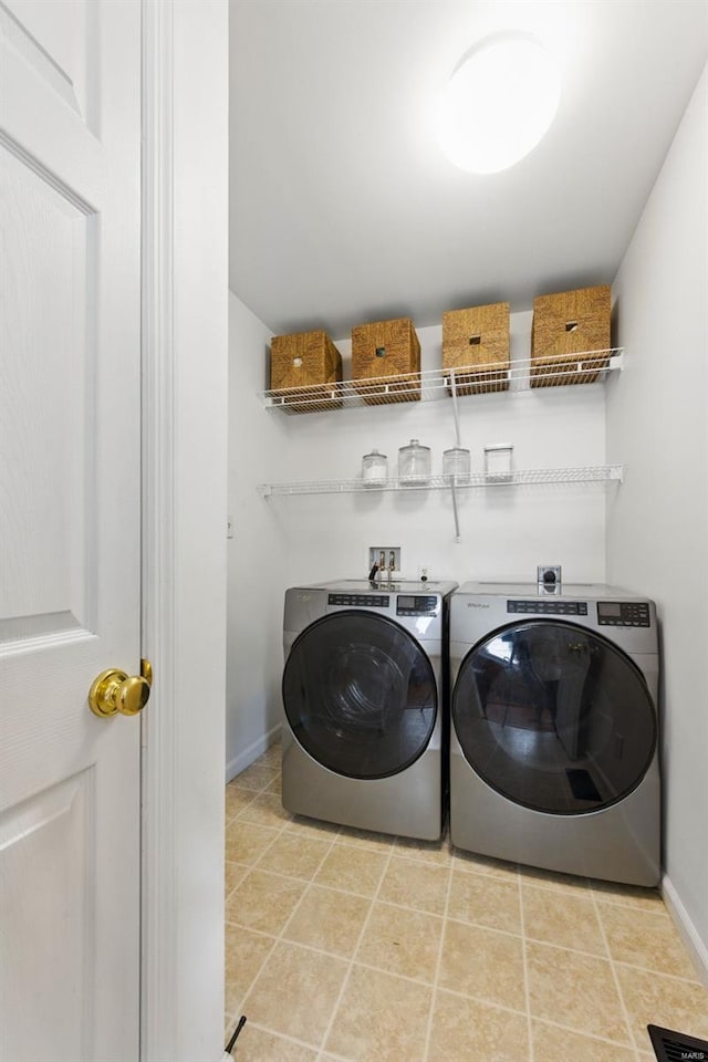 laundry room with laundry area, baseboards, and washing machine and clothes dryer