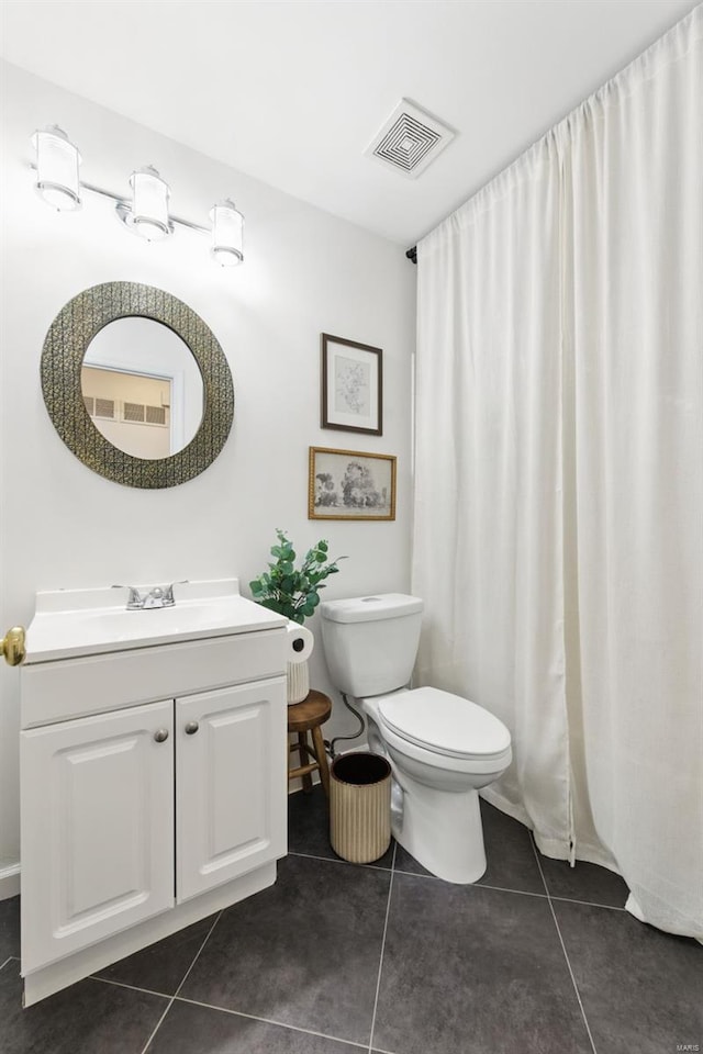 bathroom with toilet, visible vents, tile patterned flooring, and vanity