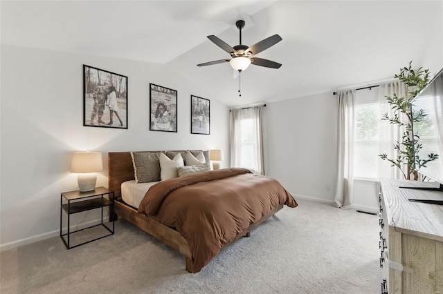 carpeted bedroom featuring baseboards, ceiling fan, and vaulted ceiling
