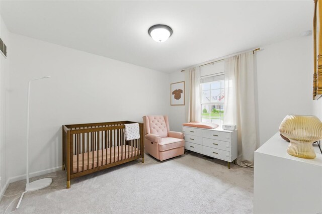 bedroom with carpet and a crib