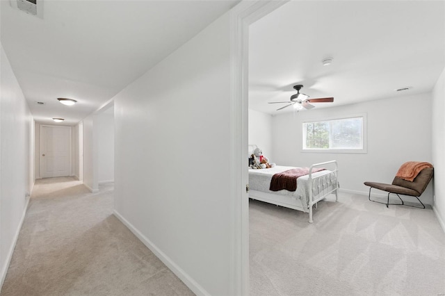 carpeted bedroom with visible vents, baseboards, and ceiling fan