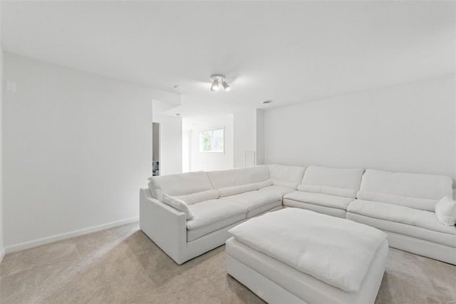 living room with baseboards and light carpet