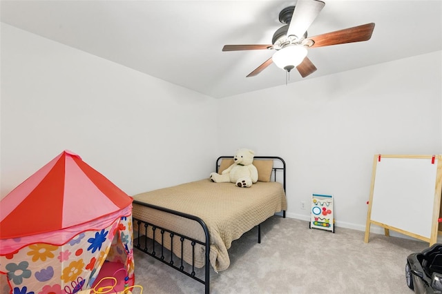 carpeted bedroom featuring baseboards and a ceiling fan