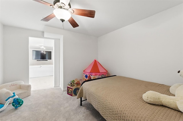 bedroom with ensuite bathroom, a ceiling fan, and carpet flooring